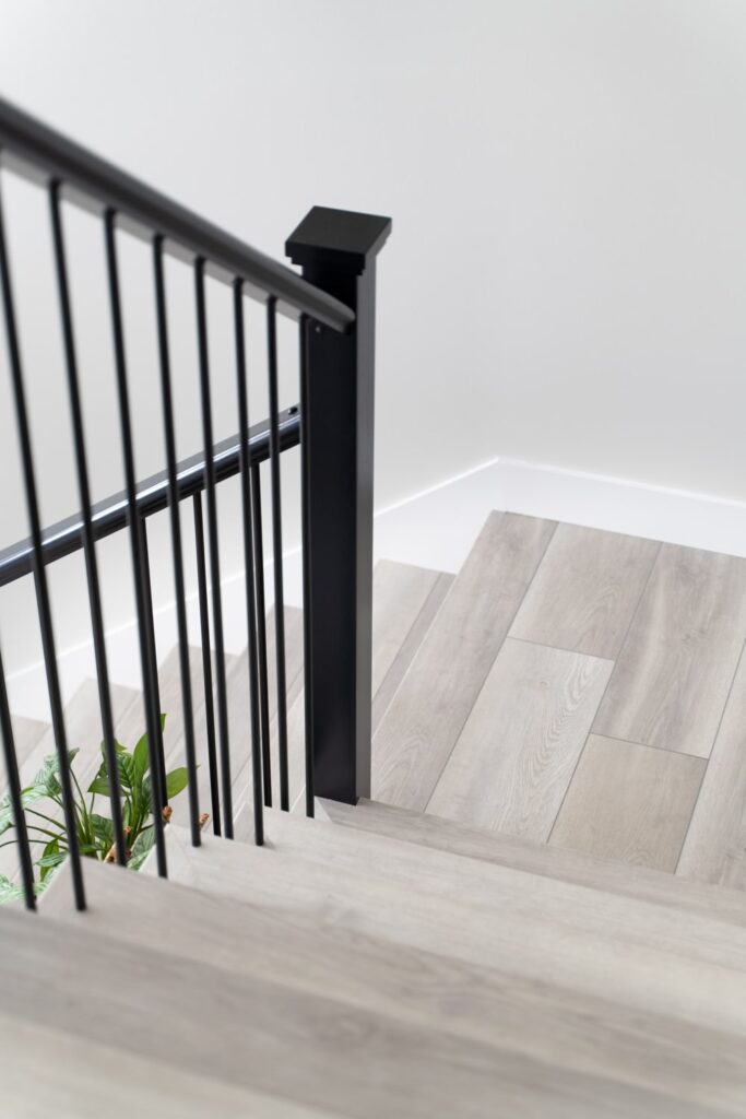 Luxury vinyl plank staircase with black balusters