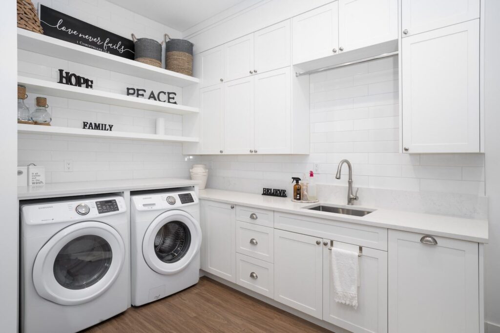 White laundry room with quartz countertops